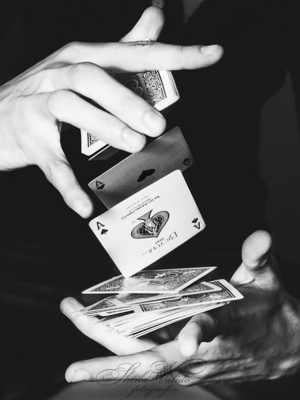 Hands shuffling a deck of playing cards
